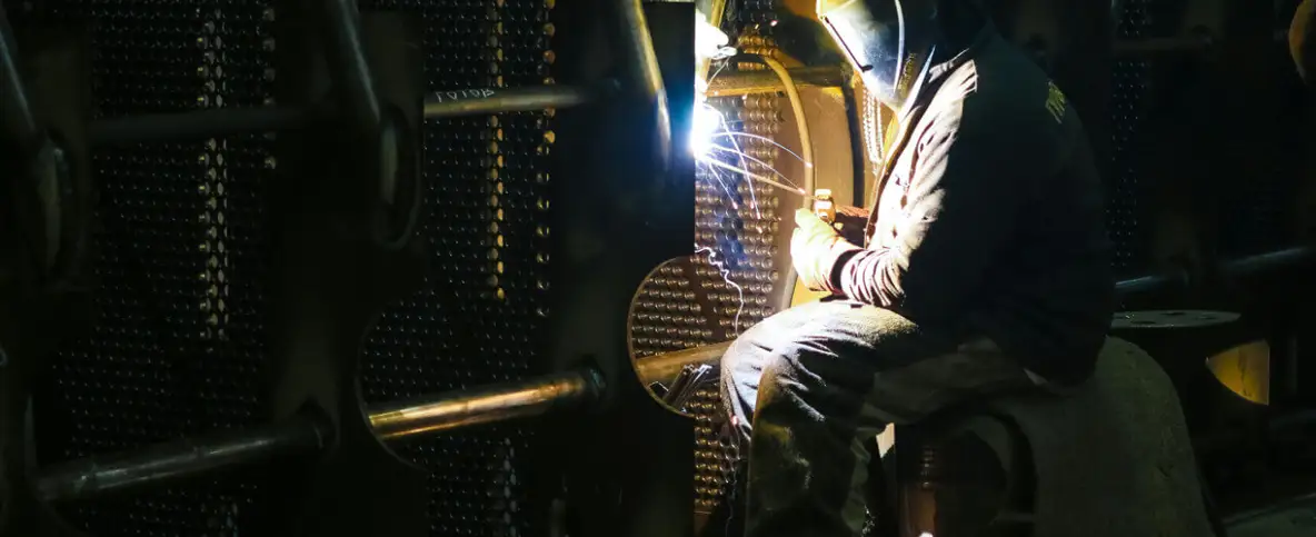 An operator doing welds on steel