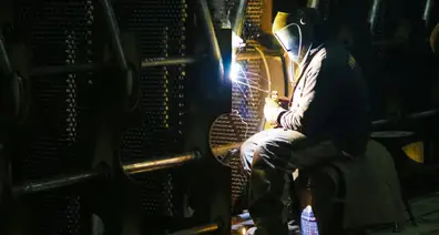 An operator doing welds on steel